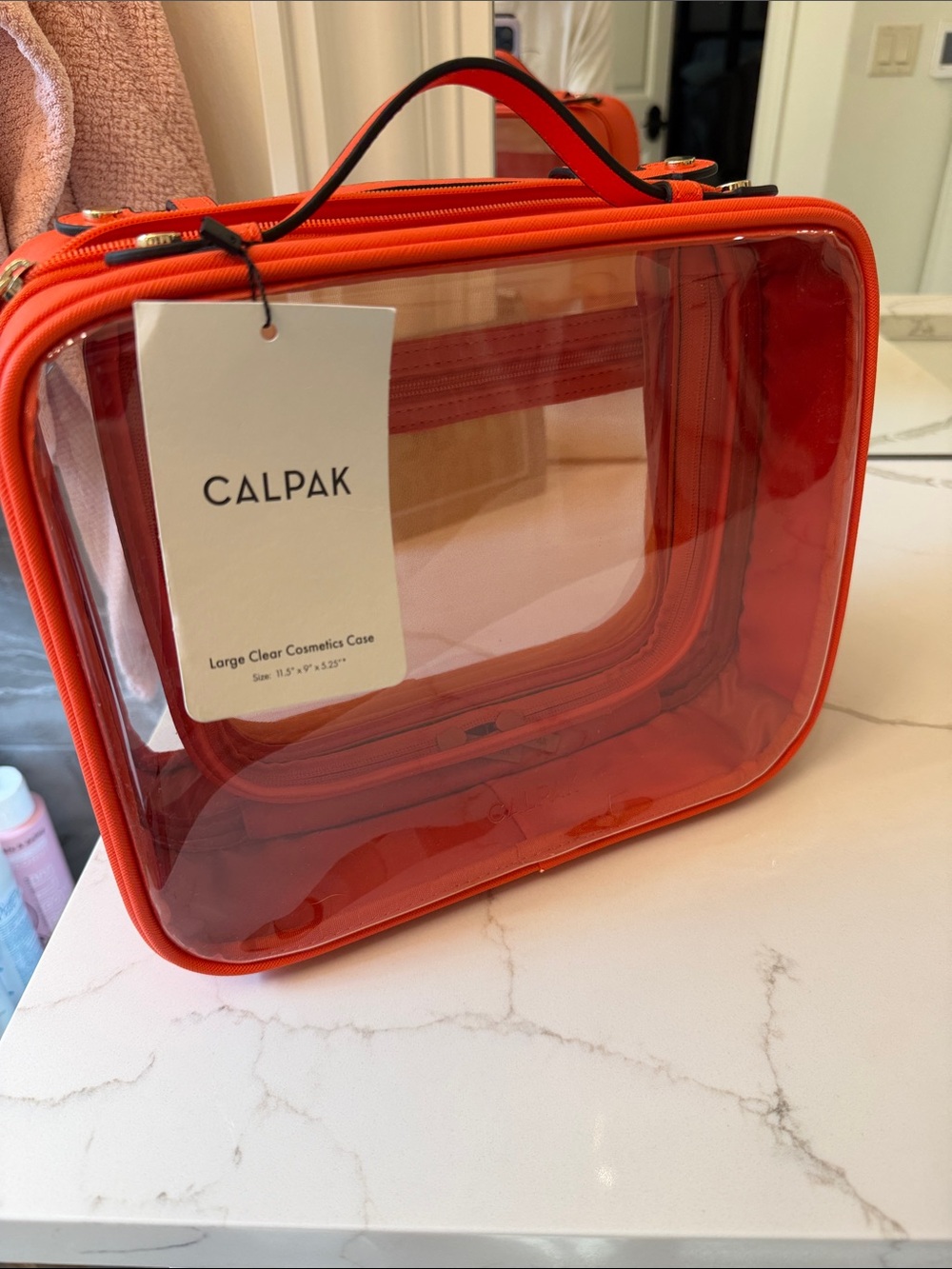 Calpak Clear Cosmetic Case in Bright Orange